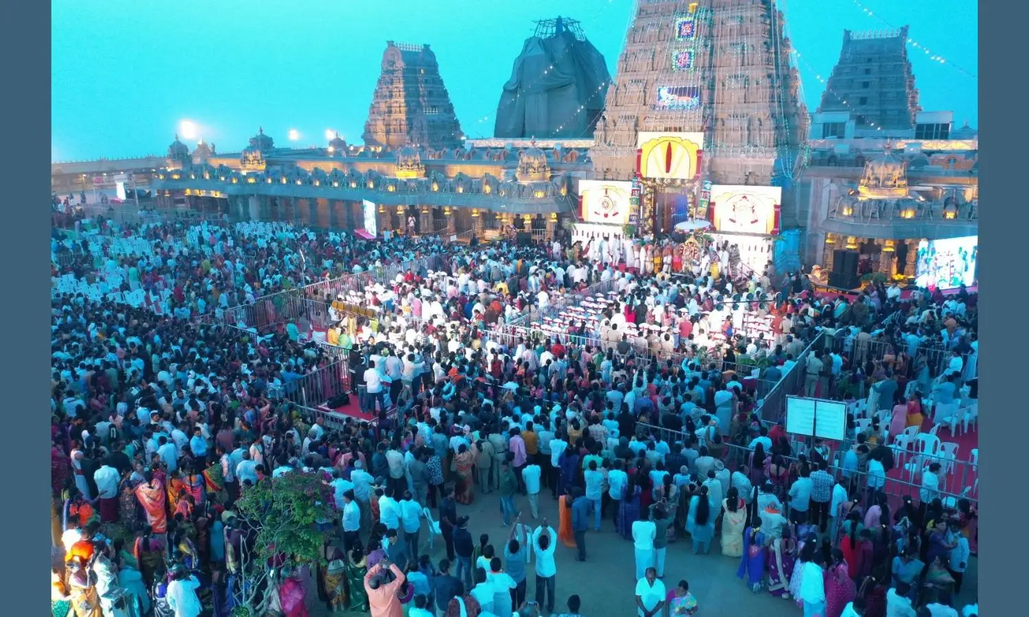 Devotees waiting in long queue for darshan at Yadagirigutta temple with spiritual rituals and lamps