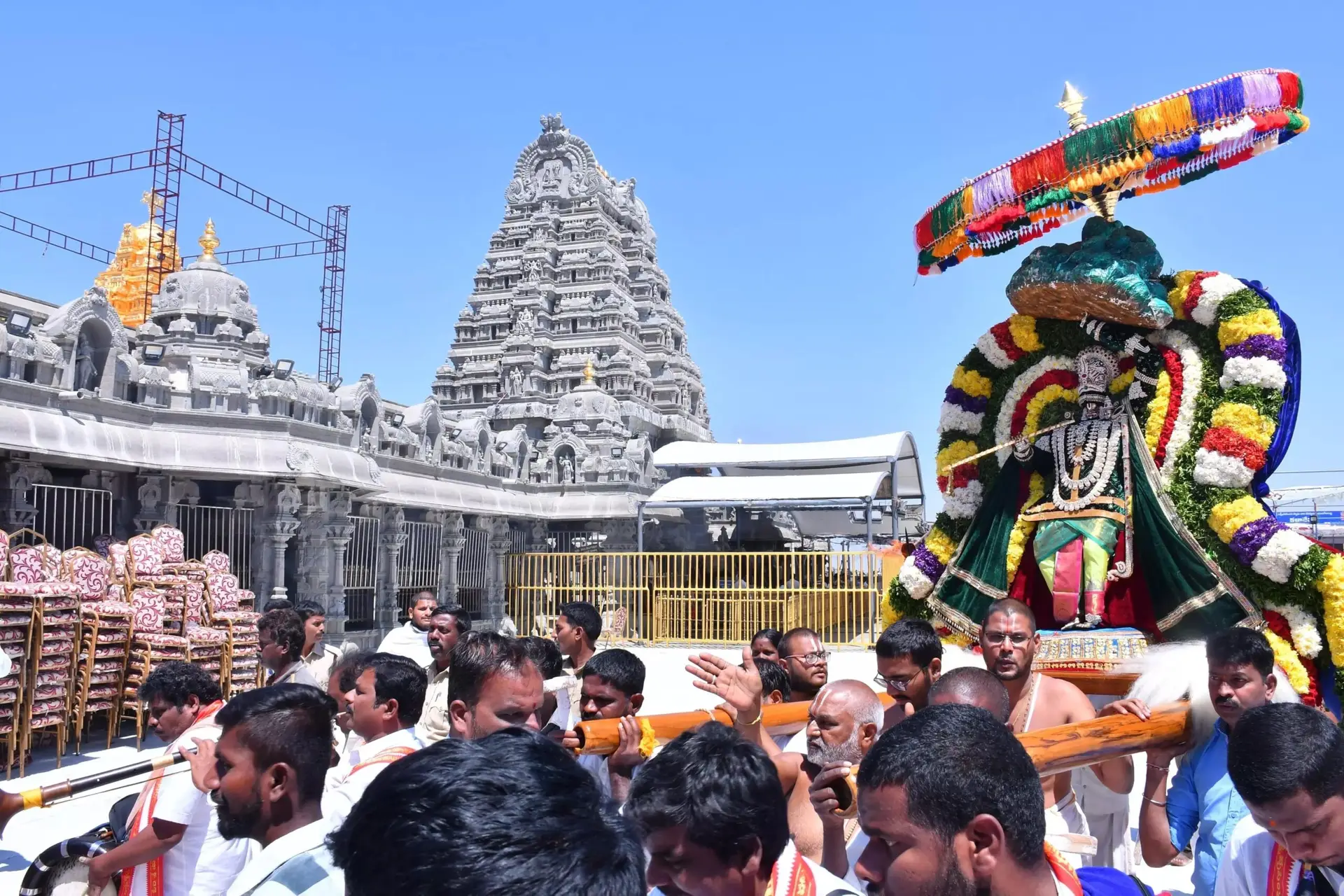 Devotees waiting in long queue for darshan at Yadagirigutta temple with spiritual rituals and lamps